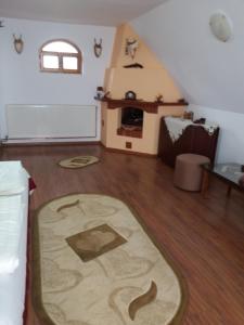 a living room with a rug on the floor at Casa Vlasea Albesti Sighișoara in Sighişoara