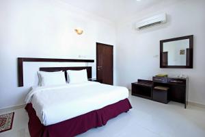 מיטה או מיטות בחדר ב-Star Emirates Furnished Apartments 2