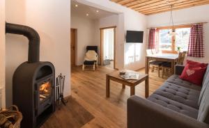 a living room with a fireplace and a couch at MarktlAlm Turracher Höhe in Turracher Hohe