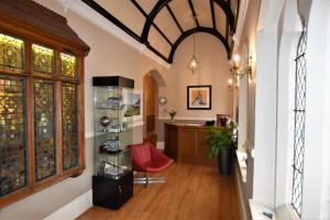 a hallway of a home with a room with a table at Taunton House Hotel in Taunton