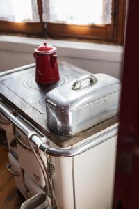 a red kettle sitting on top of a stove at La Casa delle Zie in Cologna Veneta