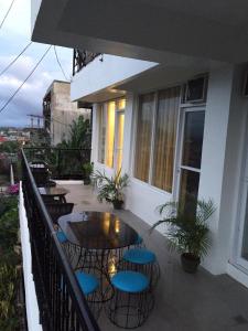 a patio with tables and chairs on a balcony at Alta Residences in Locsin +48 photos