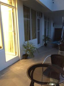 a patio with a glass table and a window at Alta Residences in Locsin