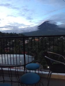 a balcony with a view of a mountain at Alta Residences in Daraga