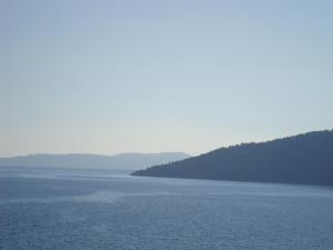 a large body of water with trees in the distance at Mikros Gialos Apartments in Mikros Gialos