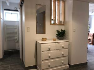 a dresser with a mirror on top of it in a hallway at L'impasse in Portbail