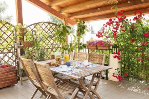 a table and chairs on a patio with flowers at La Casa delle Zie in Cologna Veneta
