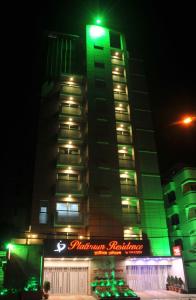 a large building with a clock on the top of it at Platinum Residence in Dhaka