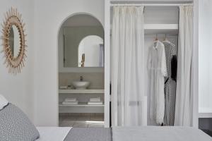 a bedroom with a closet with a mirror and a bed at Mrs Armelina by Mr and Mrs White in Naousa