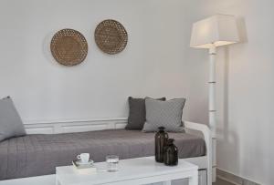 a bedroom with a bed and a table with a lamp at Mrs Armelina by Mr and Mrs White in Naousa