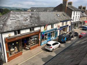 a street with cars parked in front of buildings at Number 22, Castle Street in Hay-on-Wye