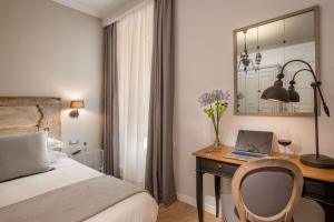 Letto o letti in una camera di Borgo Pio Charme