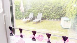 a window with a view of a yard with chairs at Haus Rehwiese in Benz