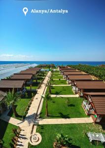an aerial view of a resort with the ocean in the background at Sedir Park - Beach Bungalow in Kargicak