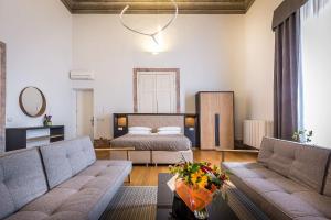 a living room with a bed and a couch at La Torre del Cestello - Residenza d'epoca in Florence