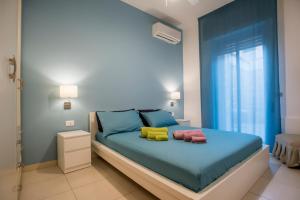 a bedroom with a bed with two pillows on it at DELPOSTO Marina di Ragusa (az) in Marina di Ragusa