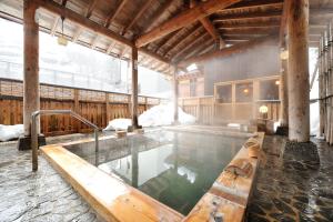 a large pool of water in a building at Hinanoyado Chitose in Tokamachi