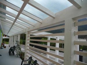 a pergola on a patio with chairs and tables at Residence Bed&Bike in Moggio Udinese