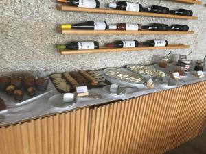 
a counter topped with lots of different types of pastries at Cró Hotel Rural e Termal Spa in Rapoula do Côa
