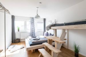 バート・ヴェーリスホーフェンにあるExklusive Design Erlebnisferienwohnungのロフトベッド1台とソファが備わる客室です。