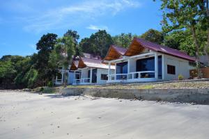 una casa sulla spiaggia con alberi sullo sfondo di Pulau Weh Paradise a Sabang