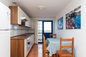 a kitchen with a table and a dining room at TAO El Cotillo - VV in El Cotillo