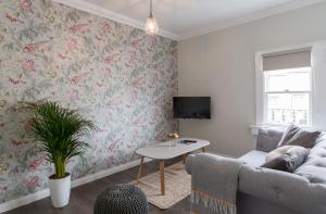 a living room with a couch and a table at Vesta Central Bath Apartment in Bath