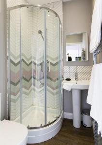 a bathroom with a shower and a sink at Vesta Central Bath Apartment in Bath