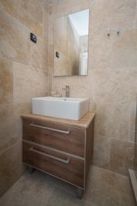 a bathroom with a sink and a mirror at Apartments Vila Monegro in Bar +37 photos