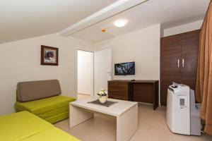 a living room with a couch and a table at Apartments Valentino in Ohrid