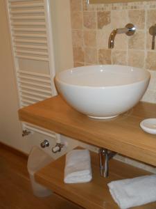 a bathroom with a white bowl sink on a wooden counter at Al Coppo in Sirolo