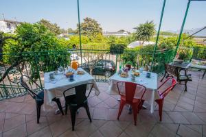 two tables and chairs sitting on a balcony at Villa Rocla guest house Pompei in Pompei