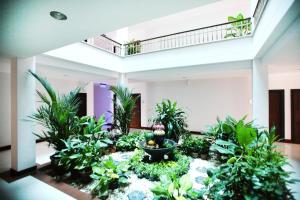 a large room with plants and a staircase at Pattara Place in Chiang Mai