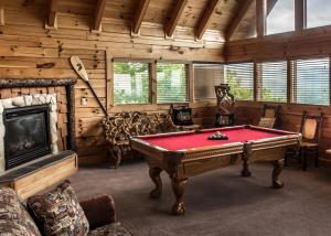 a room with a pool table and a fireplace at The Honeymoon Sweet #63 in Sevierville