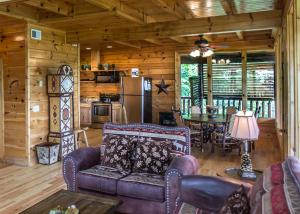 a living room with a couch and a table in a cabin at The Honeymoon Sweet #63 in Sevierville