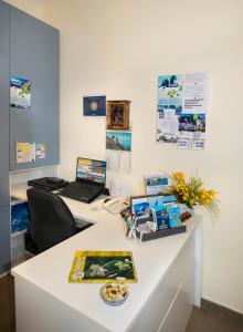 an office with a desk with a laptop on it at YourHome - Casa Aristide in Sant'Agnello