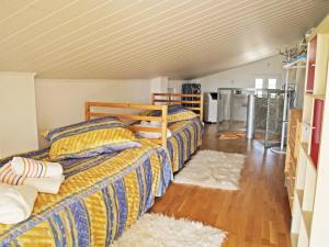 a bedroom with three beds and two rugs at Perikleshills in Thermisia