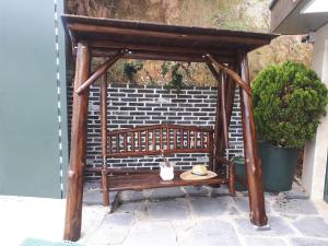 a wooden gazebo with a table on a patio at For You Hostel in Yeosu