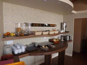 a kitchen with a counter with food on it at Hotel Restaurant Le Parc in Moulins