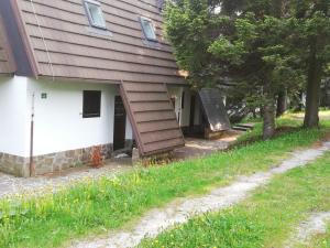 a house with a staircase on the side of it at Rogla Apartma Gaber54 in Zreče +4 photos