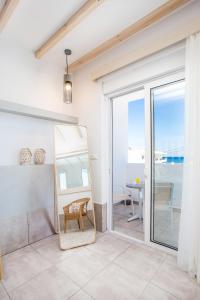 a living room with a mirror and a table at Alexander Studios & Suites - Adults Only in Faliraki