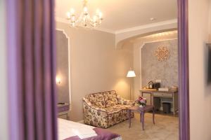 a living room with a chair and a table at Artisans Boutique Villa in Sibiu