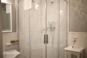 a shower with a glass door in a bathroom at Artisans Boutique Villa in Sibiu +100 photos