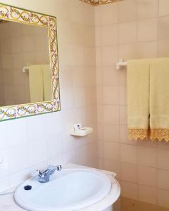 a bathroom with a sink and a mirror and towels at Casa da Mae in Salir