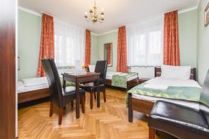 a room with a table and chairs and a dining room at Hostel Biały Dom in Krakow