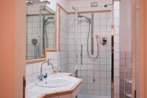 a bathroom with a sink and a shower at Casa vacanze a Rubbianello in Monterubbiano +9 photos