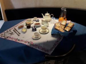 a table with a table cloth with a tea set on it at Bed and Breakfast Silvana in Taranto