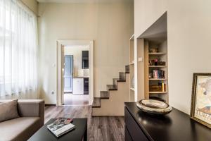 a living room with a couch and a staircase at TREASURE BOX - Entire Apartment in the center in Budapest