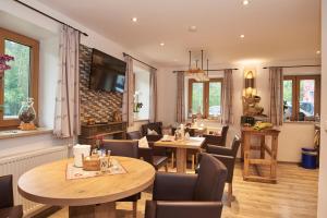 a dining room with two tables and chairs at Gästehaus Achental in Berchtesgaden