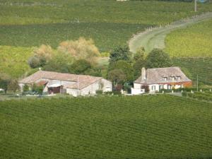 an aerial view of a house in a field at Le Miroir des Etoiles in Pomport